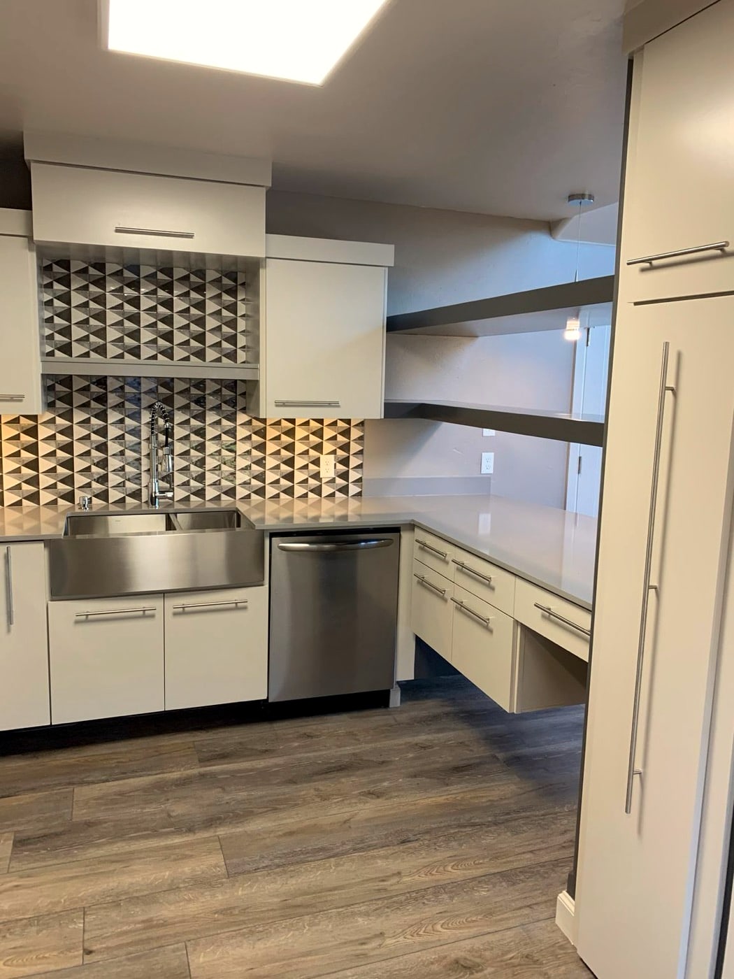 Kitchen with farmhouse sink and black-and-white tile backsplash